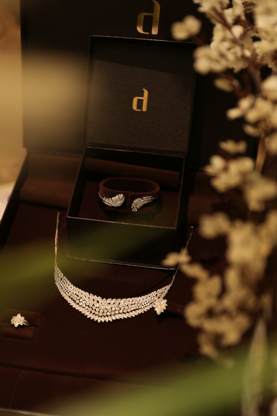 Diamond jewelry displayed inside a dark brown velvet box.