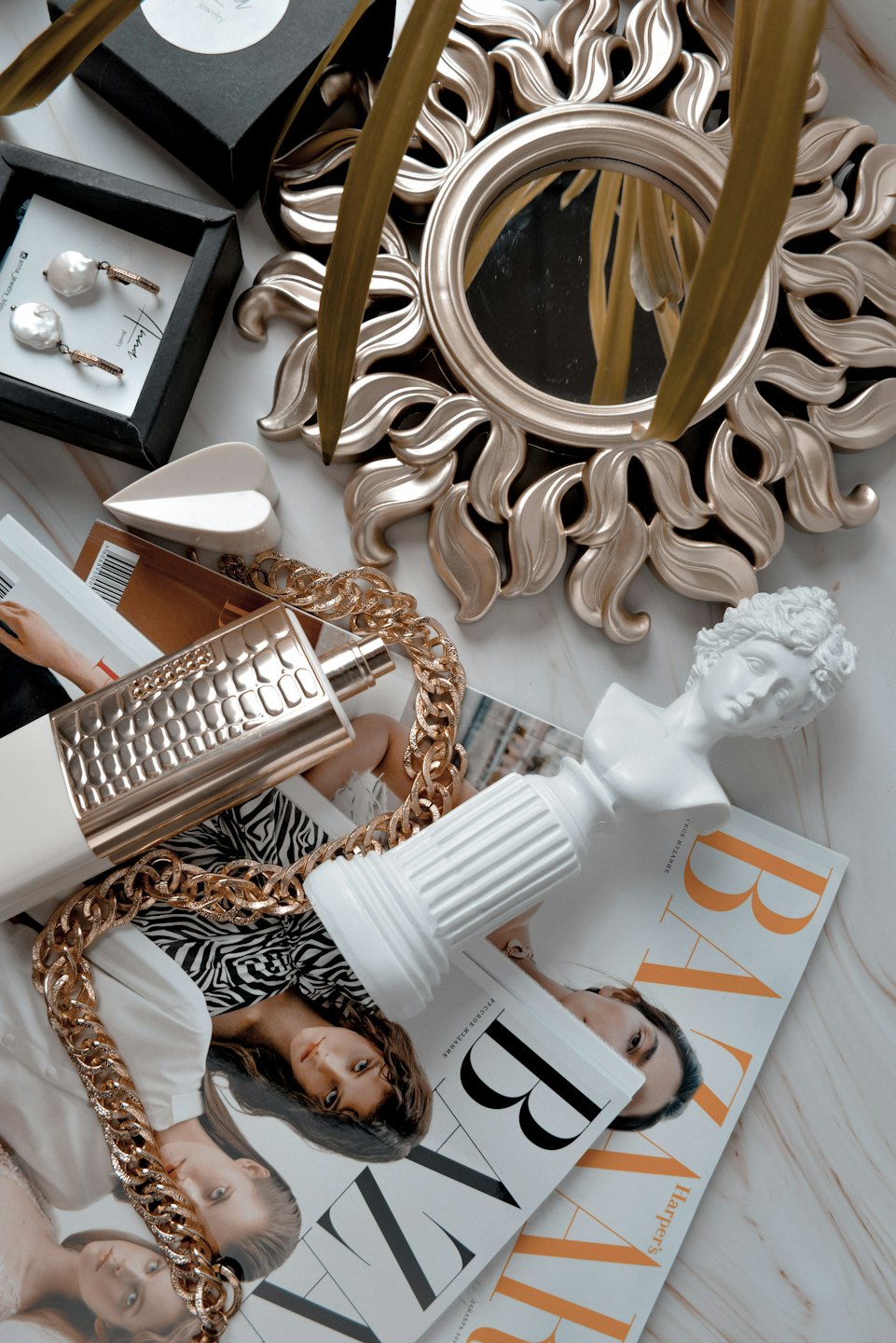 Fashion accessories and decor displayed on a marble surface.